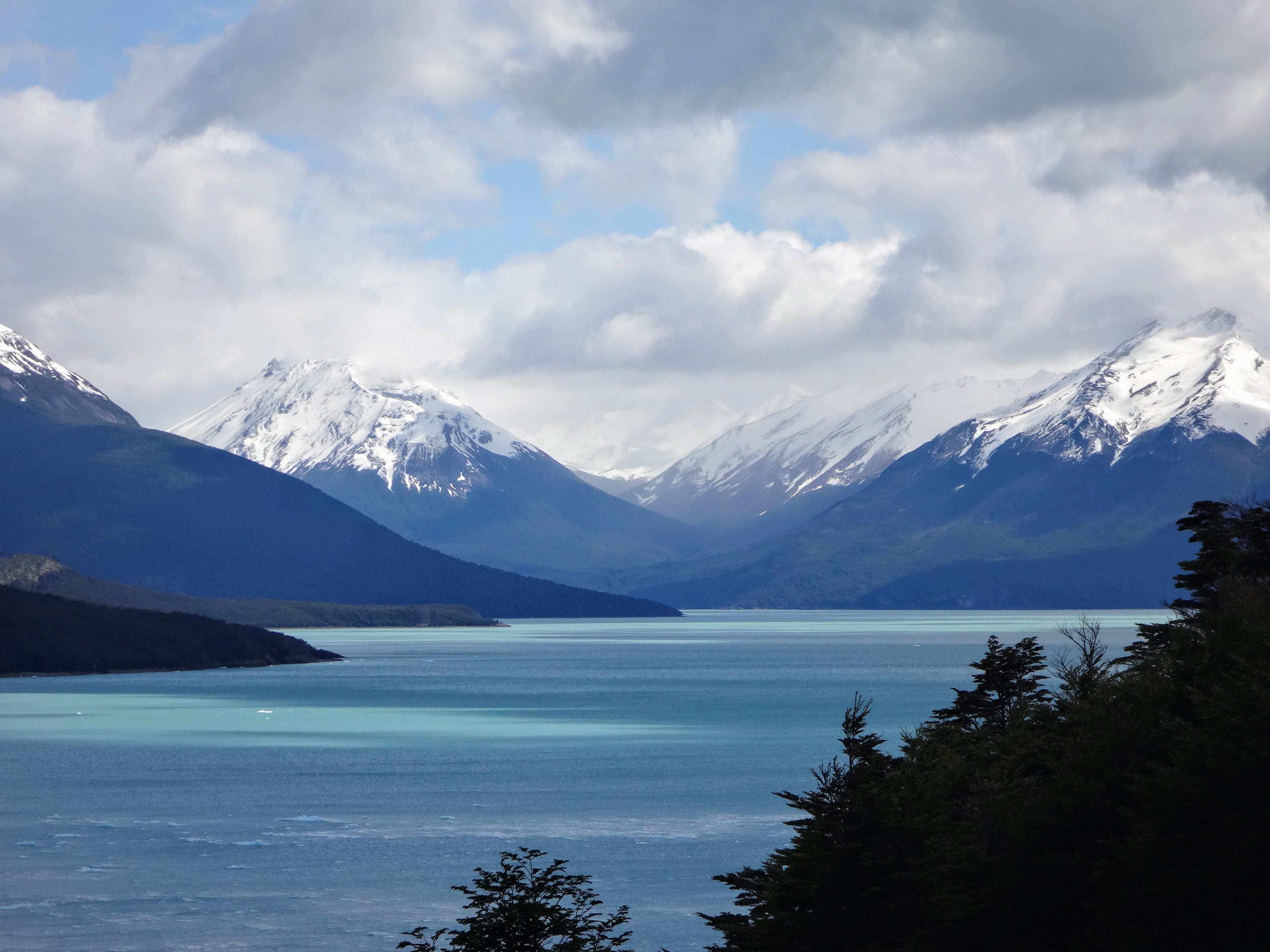 Snow-capped mountain peaks and blue lake